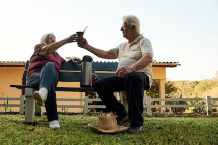Exterior, an elderly couple enjoy a drink whilst sitting in the garden, for “Have Any of These Historical Events Shaped Your Alternative Investment Strategy?”