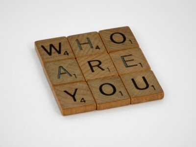Scrabble tiles reading 'Who Are You', for "What’s Your Alternative Asset Investing Personality?"