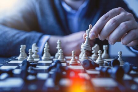 Someone moving a king in game of chess, for "Which High-Net-Worth Tax Strategy Could Work for You?"